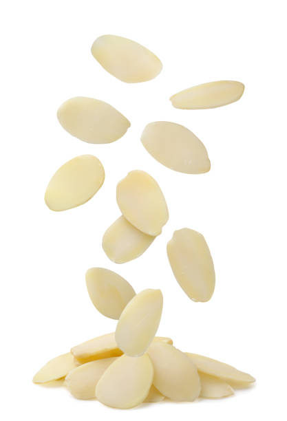 Almond flakes falling on a pile on a white background. Isolated