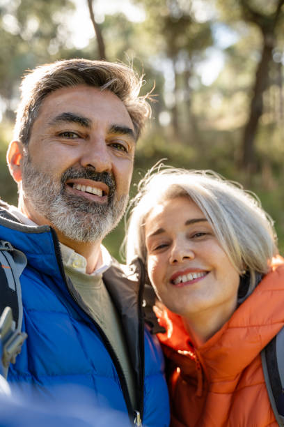 istock Hikers smiling and taking a selfie in the woods 2195234321
