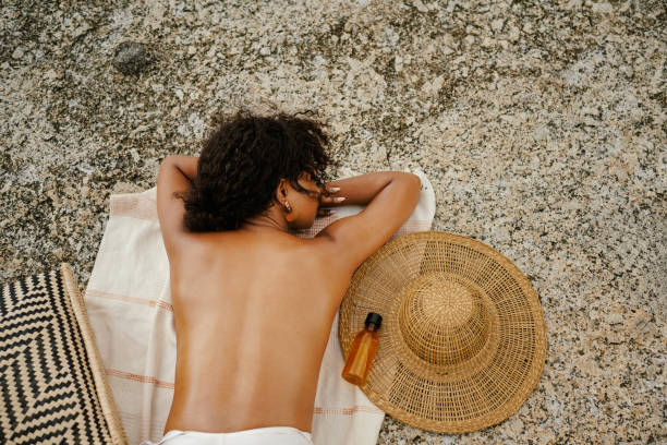 istock Relaxing Outdoors on a Sunny Day with Straw Hat and Beach Essentials 2195235526
