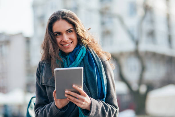 istock Young Woman Using a Tablet in an Urban Environment 2195235548