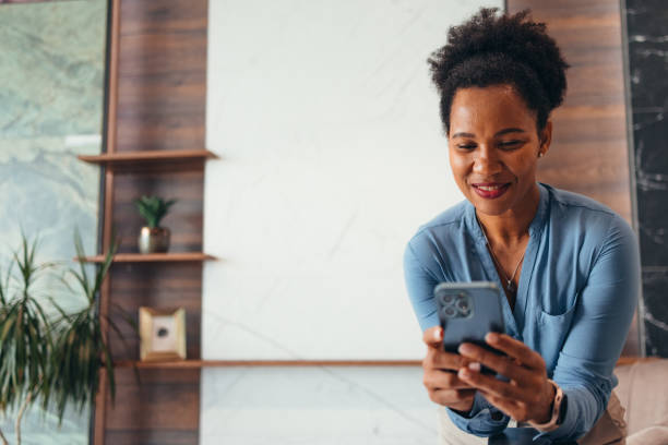 istock Young businesswoman using mobile phone in modern office 2195236679