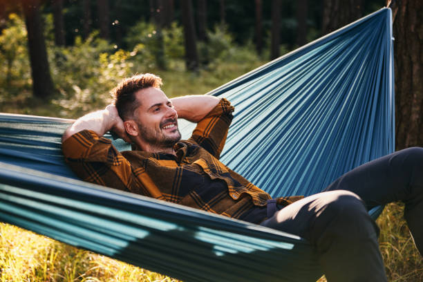 istock Relaxed adult man in hammock in forest 2195237544