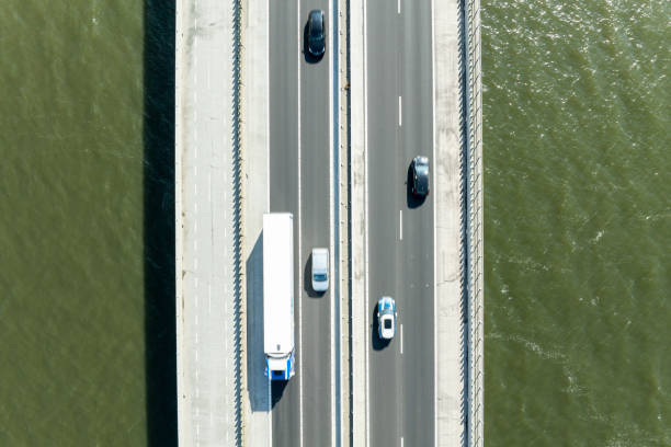 istock Bridge over a lake with traffic on the highway seen from above 2195238405