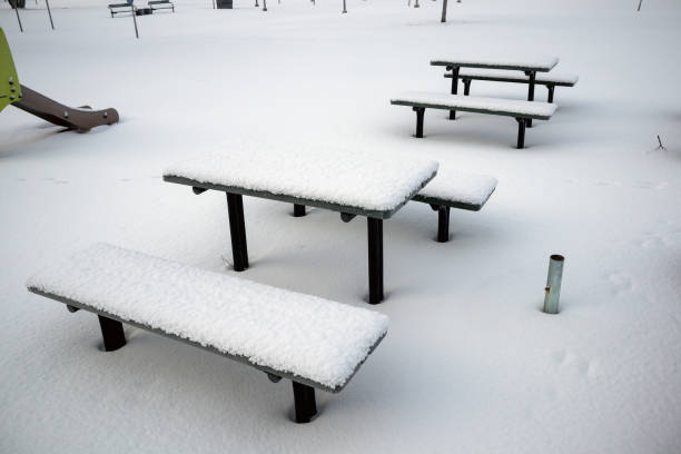 istock Snow-covered benches and tables in the park 2195238582