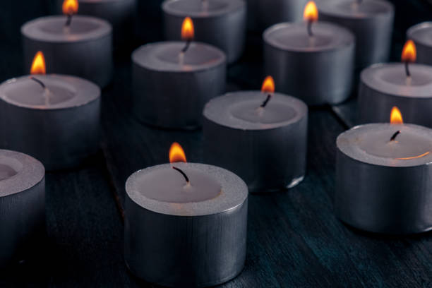 istock Tea light candles on a dark background, many lights in the dark 2195239763