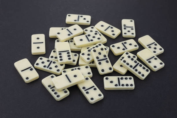 istock Big heap from dominoes on a dark background 2195240559
