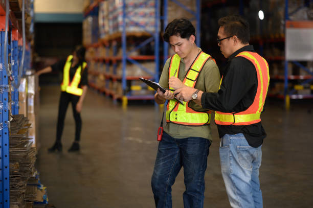 istock Warehouse worker working and checking the stock in the warehouse. .Factory manager using digital tablet check barcode in industry factory logistic. 2195240832