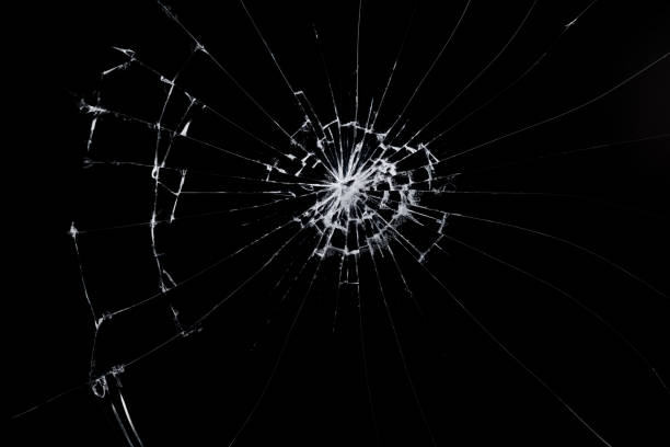 istock cracks on the glass impact on the glass, abstract background broken window damage 2195240997