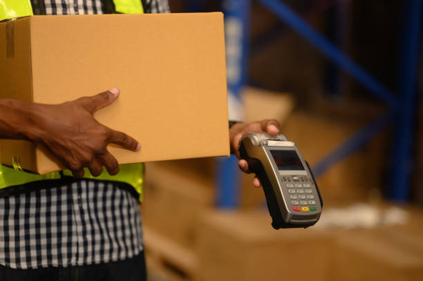 istock Deliveryman holding box and payment terminal, credit card device, client care 2195241245