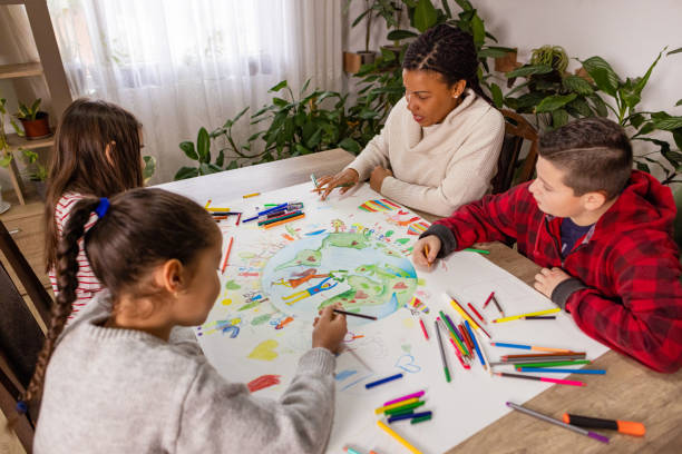 istock Children and teacher drawing together 2195241456