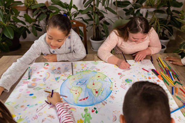istock Children Join Hands to Create Earth Day Art 2195243406