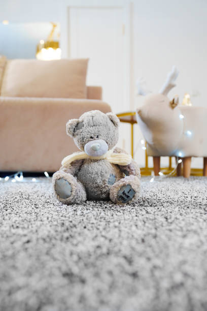 istock close-up. teddy bear on the grey Interior pile carpet made of polypropylene. 2195246904