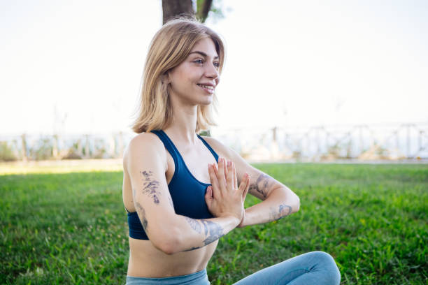istock Woman doing meditation in park 2195246965