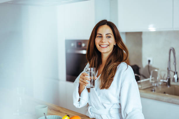 istock Smiling Woman Enjoying a Morning Beverage in a Modern Kitchen 2195248408