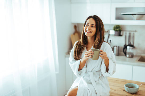 istock Smiling Woman Relaxing With Morning Coffee In Modern Kitchen 2195248410