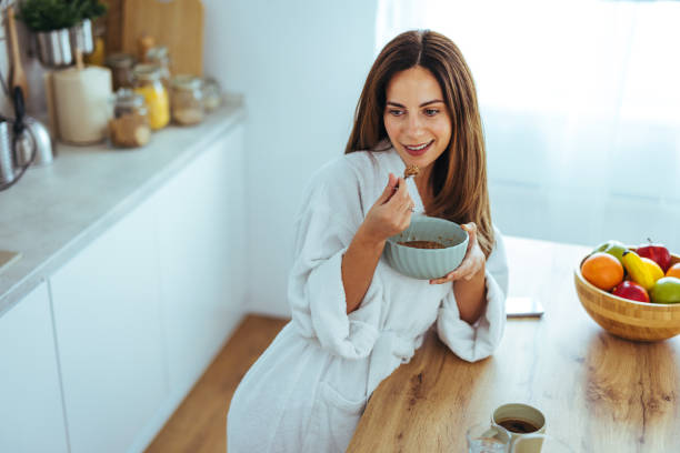 istock Woman Enjoying A Healthy Breakfast In Her Cozy Kitchen Setting 2195248453