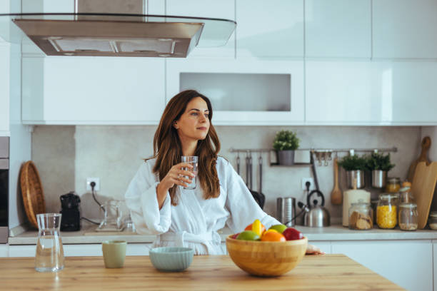 istock Woman Enjoying Morning Beverage in a Modern Kitchen Setting 2195248461