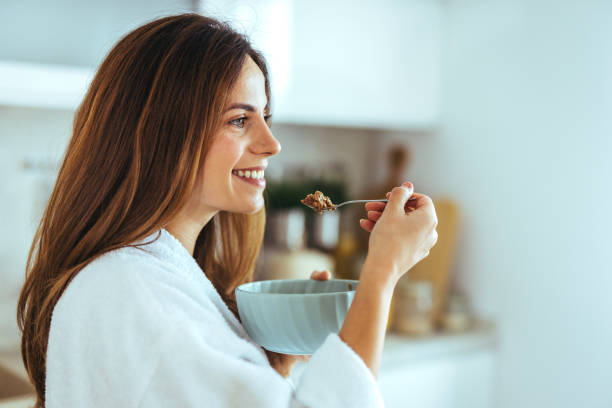 istock Woman Enjoying Healthy Breakfast in a Cozy Home Kitchen Setting 2195248466
