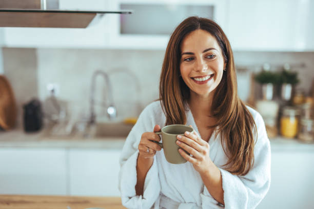 istock Relaxed Woman Enjoying Morning Coffee in a Cozy Kitchen Setting 2195248476