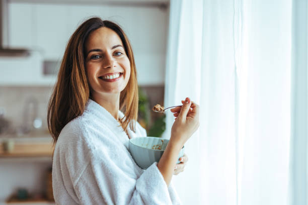 istock Happy Woman Enjoying Breakfast in a Cozy Kitchen Setting 2195248477