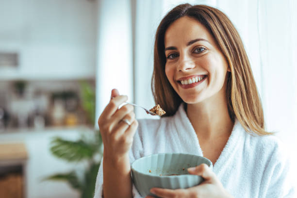 istock Smiling Woman Enjoying a Healthy Breakfast in a Bright Kitchen 2195248480