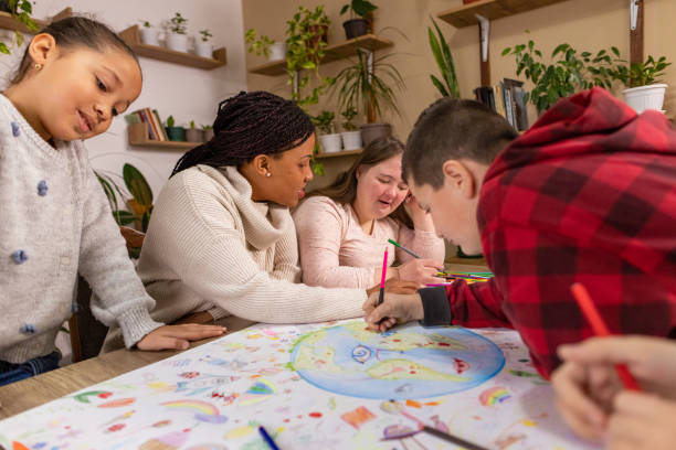 istock African American Teacher Helps Kids Paint Earth 2195250198