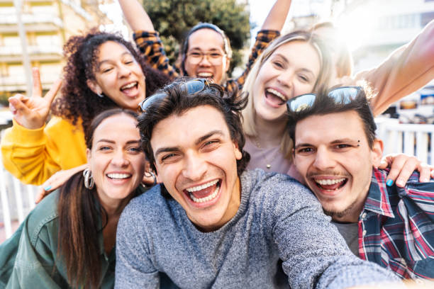 istock Multicultural friends smiling at camera together outside - Happy young people taking selfie with smart mobile phone device walking on city street - Youth community and technology concept 2195252568