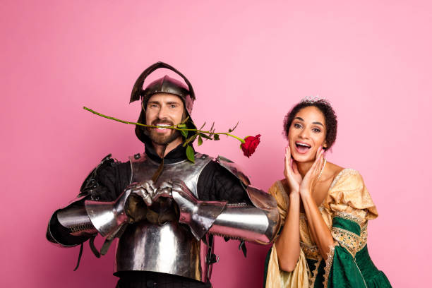 istock Couple in medieval attire posing with romantic vibes on a vibrant pink background 2195252849