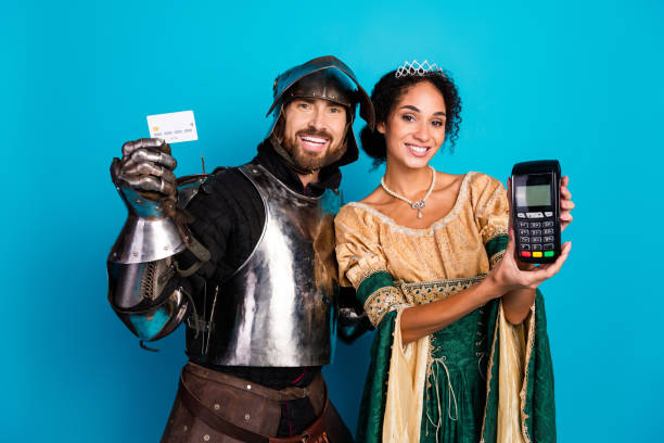 istock Couple in themed costumes posing with modern electronic devices on blue background 2195252977