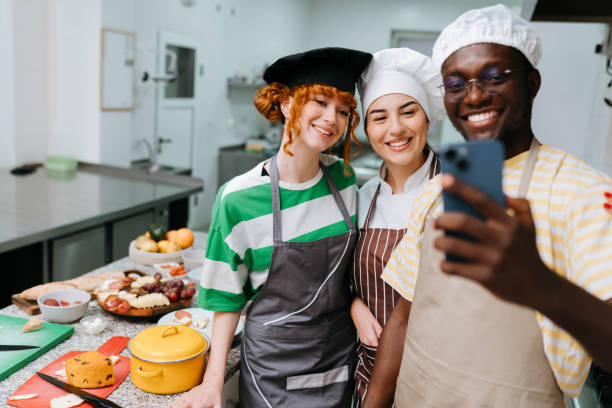 istock Playful instructor taking a selfie with friends in a cooking workshop 2195253138