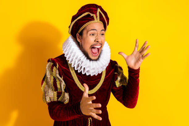 istock Young man dressed as a medieval nobleman posing theatrically against a bright yellow background 2195253727