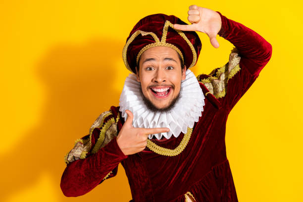 istock Cheerful nobleman dressed in historic attire on yellow background, expressing joy 2195253762