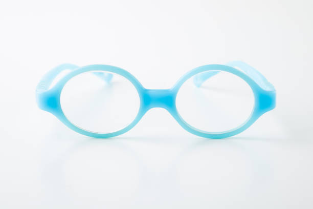 istock Baby blue eyeglasses with round soft rubber frame on light gray table background. Closeup. Front view. 2195254305