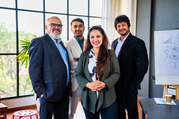 istock Indian Asian Confident corporate team standing with arms folded, smiling in an office setting 2195254434