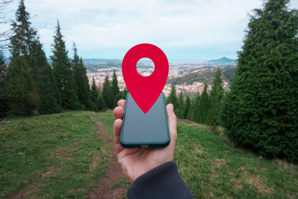 istock hand holding a smart phone searching location, with a gps symbol 2195257488