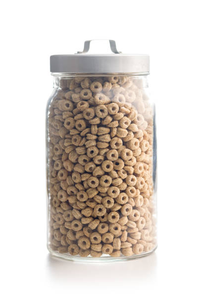 Sweet honey cereal rings in jar isolated on a white background.