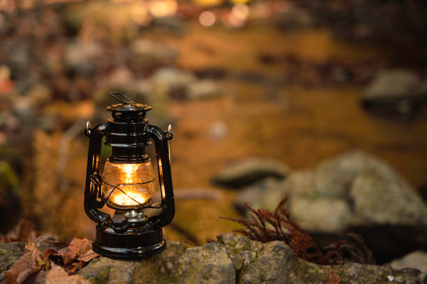 istock By the riverbank, lit lanterns, autumn camp 2195258075