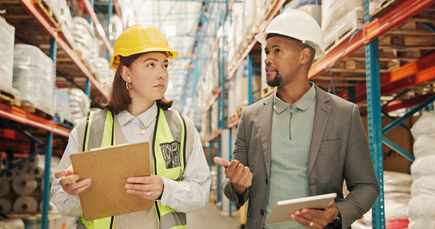 istock Logistics, people or discussion in warehouse with checklist, stock control or backlog management app. Inspector, team or tech in storage for freight distribution, export planning or delivery schedule 2195258283