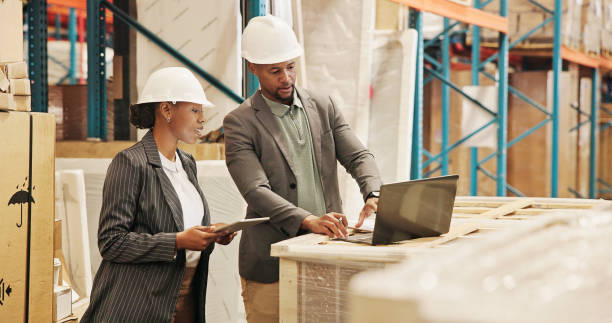 istock Collaboration, planning and people with laptop, logistics and quality control for distribution. Warehouse, teamwork and engineer with checklist for goods, conversation and discussion for shipping 2195258291