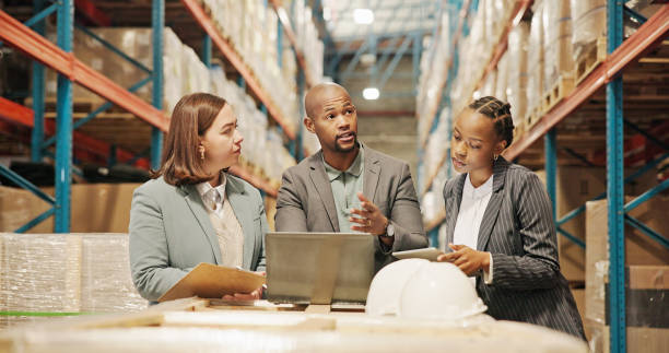 istock Women, man and tablet for logistics with laptop, discussion or planning with teamwork, inspection and distribution. People, partner and touchscreen with app, computer and storage plant at warehouse 2195258301