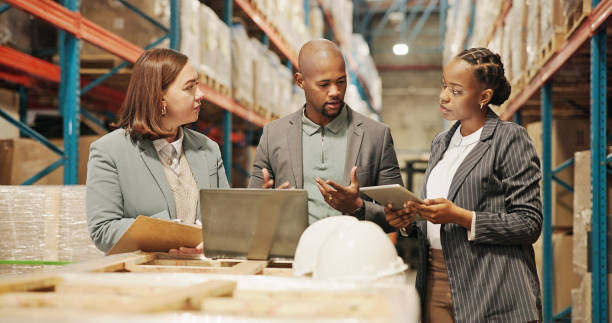 istock Man, women and tablet for distribution with laptop, discussion or planning with teamwork, inspection or logistics. People, partner and touchscreen with app, computer and storage plant at warehouse 2195258305