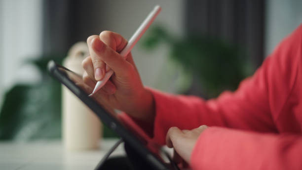 istock Teenager working on digital tablet. 2195259000