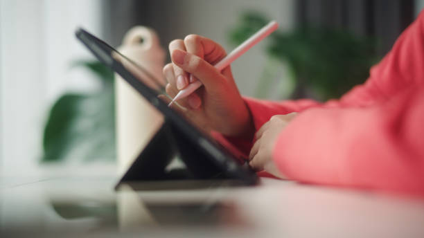 istock Teenager working on digital tablet. 2195259016