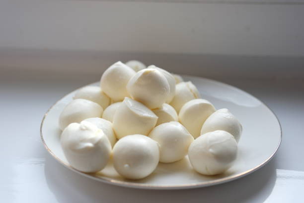 istock Many fresh white mozzarella cheese balls on spoon 2195262316