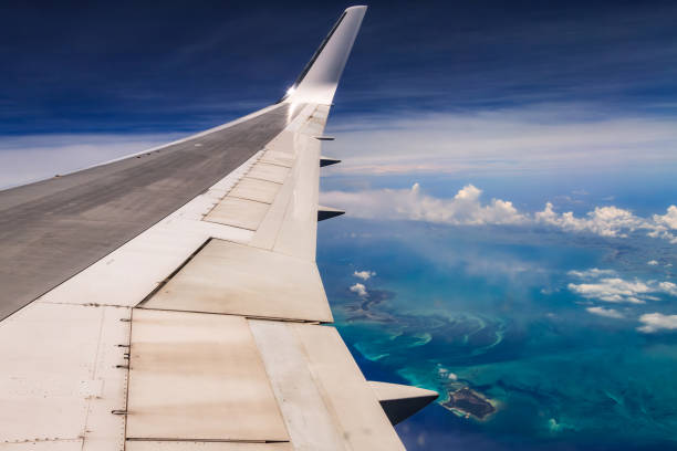istock Aerial view of airplane wing over blue sky 2195262787