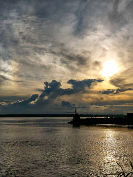 Stunning sunset scene of an Amazon boat called Gaiola on river Rio Negro near the city of Manaus, Amazon state, Brazil.