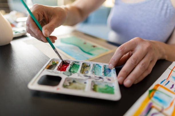 istock Woman paints with water colors 2195265156