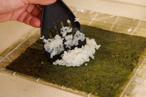 istock Sushi Making Process: Essential Steps from Bamboo Mat to Filling 2195265180