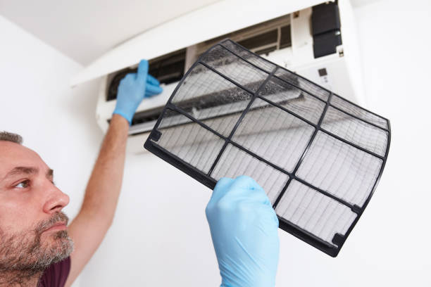 istock Man cleaning and maintaining air condition unit at home. 2195267373