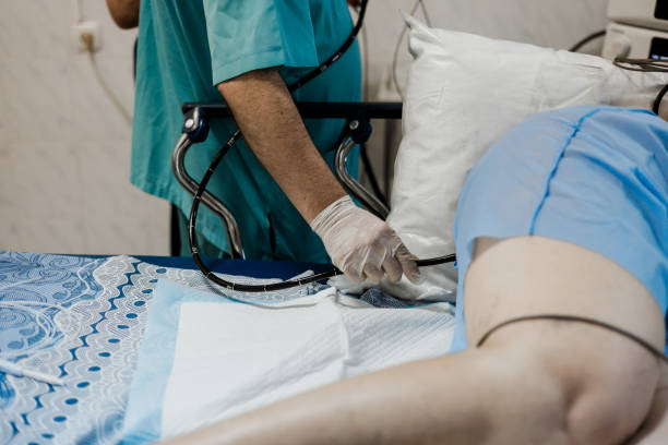 istock endoscopist performing colonoscopy, endoscope for colonoscopy, intestinal examination, gastroscopy, hospital, patient lying on couch, cancer prevention, operating room, examination with endoscope 2195270757